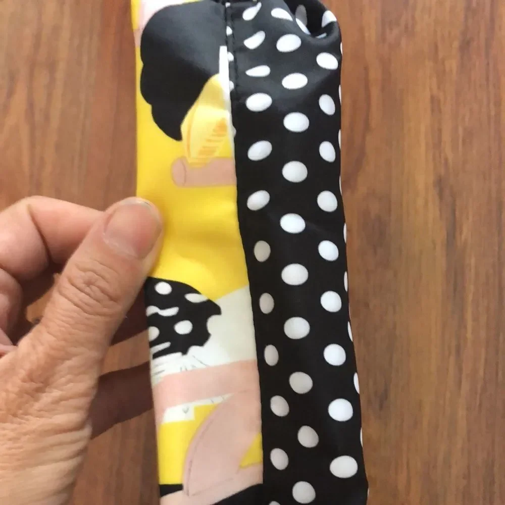 Estee Lauder Harpers Bizarre black and yellow cosmetic case.